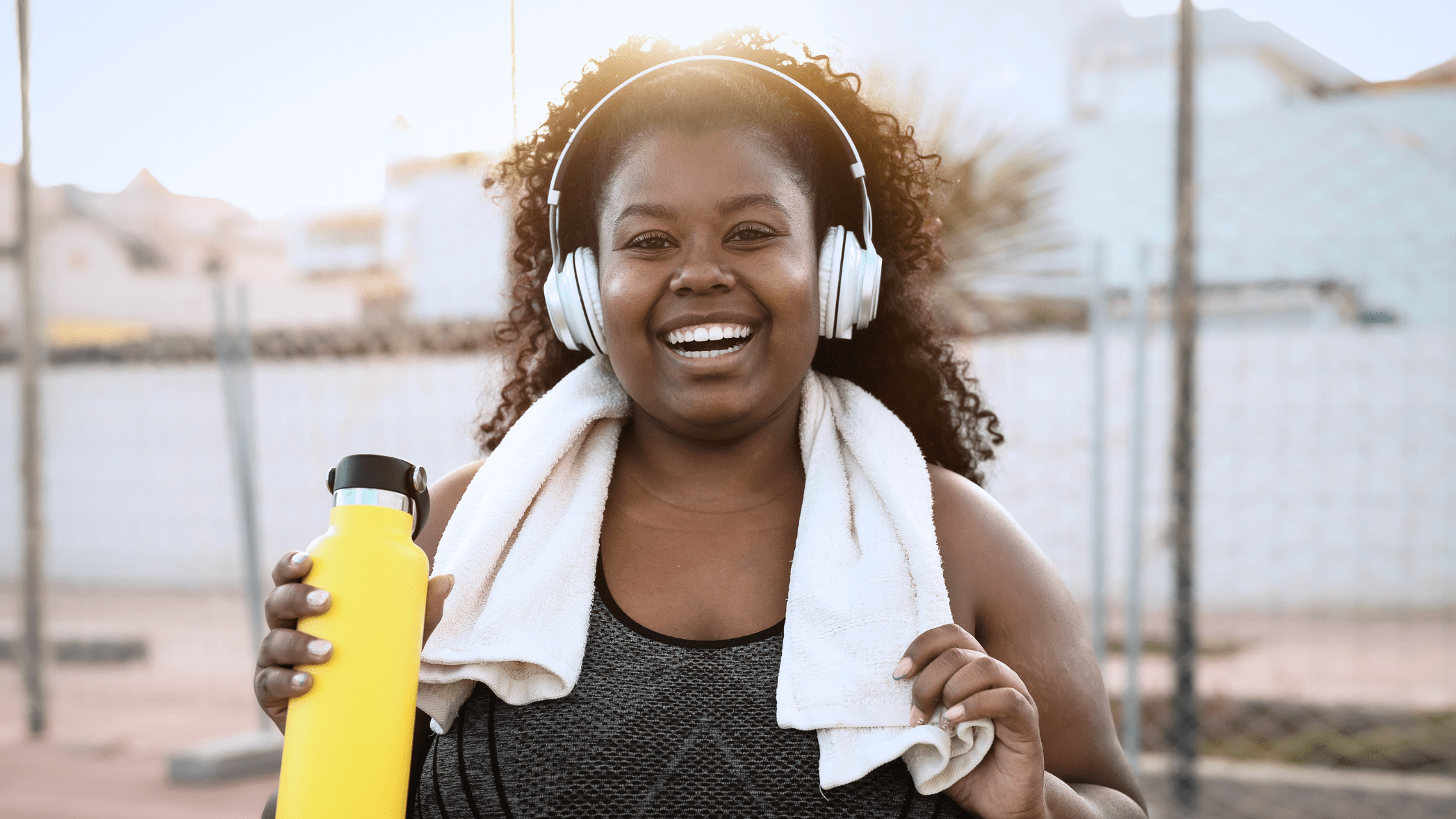 Woman smiling in her workout gear after treating her glp-1 nausea with Reliefband