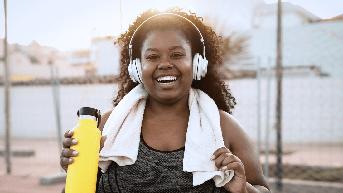 Woman smiling in her workout gear after treating her glp-1 nausea with Reliefband