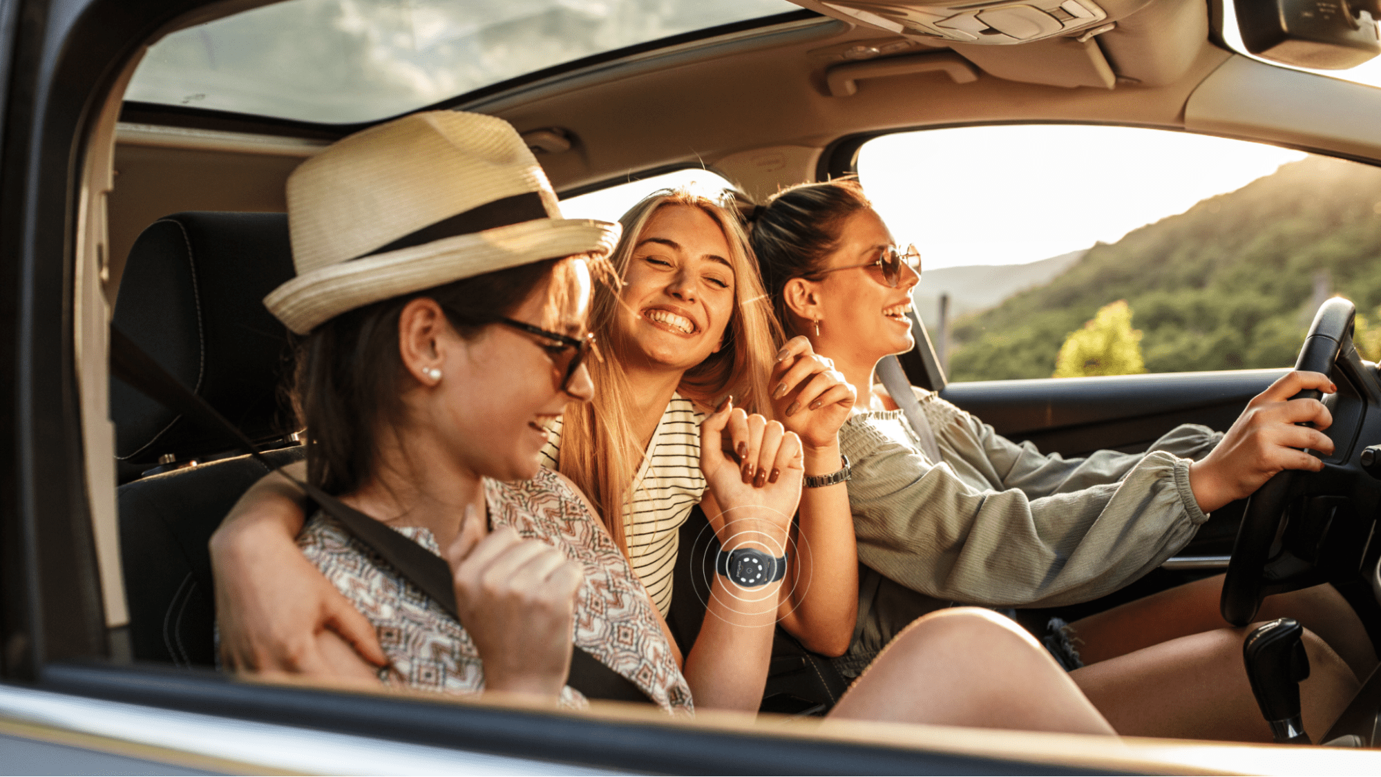 Three women riding happily in a car. One woman wears Reliefband's neuromodulation technology on her wrist to stop nausea.